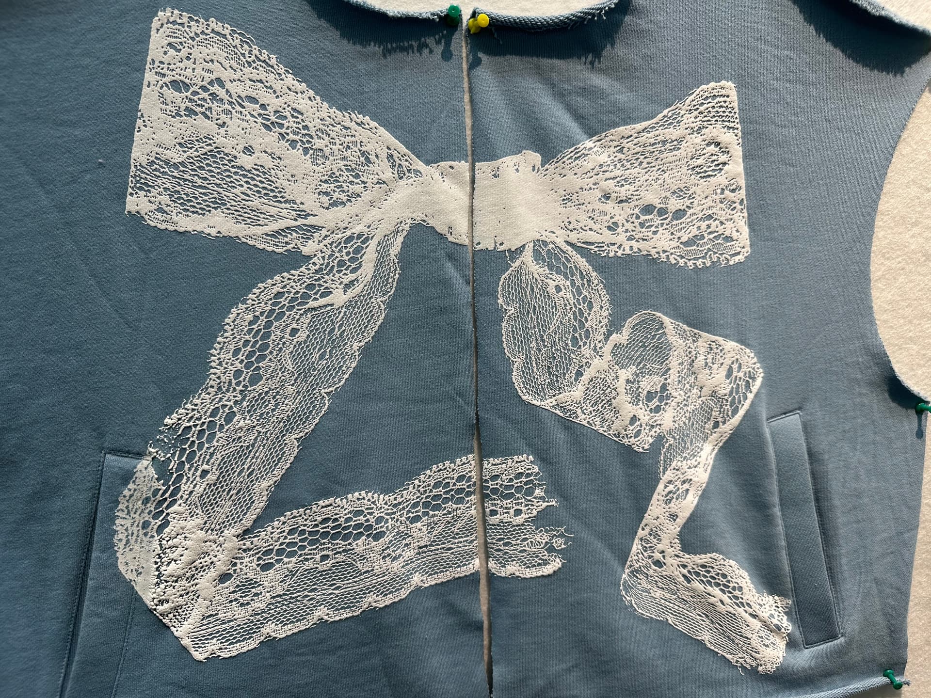 Lace appliqué detail on hoodie — handcrafted design sample